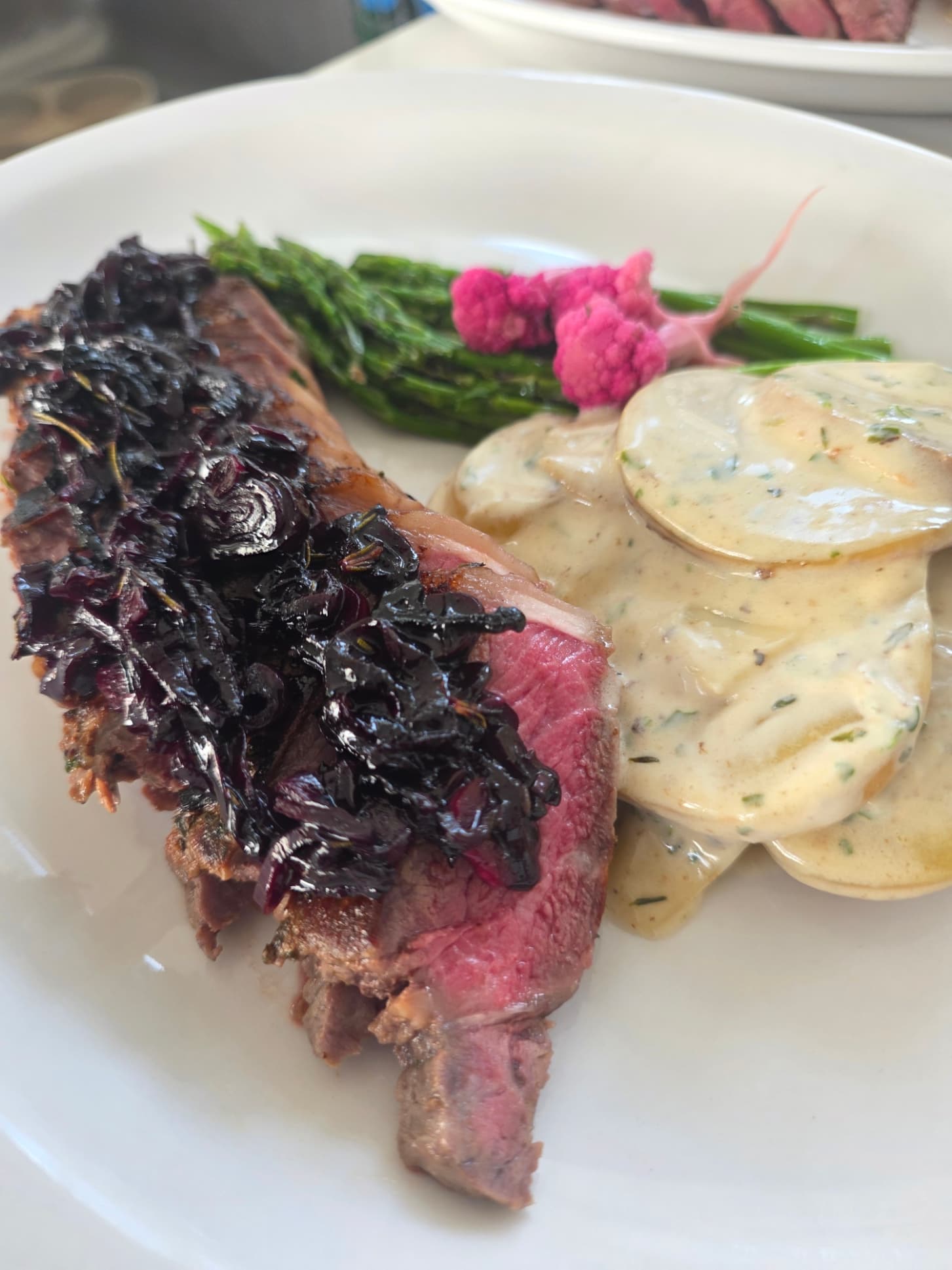 Herb-Crusted New York Strip with Parmesan Potato Gratin