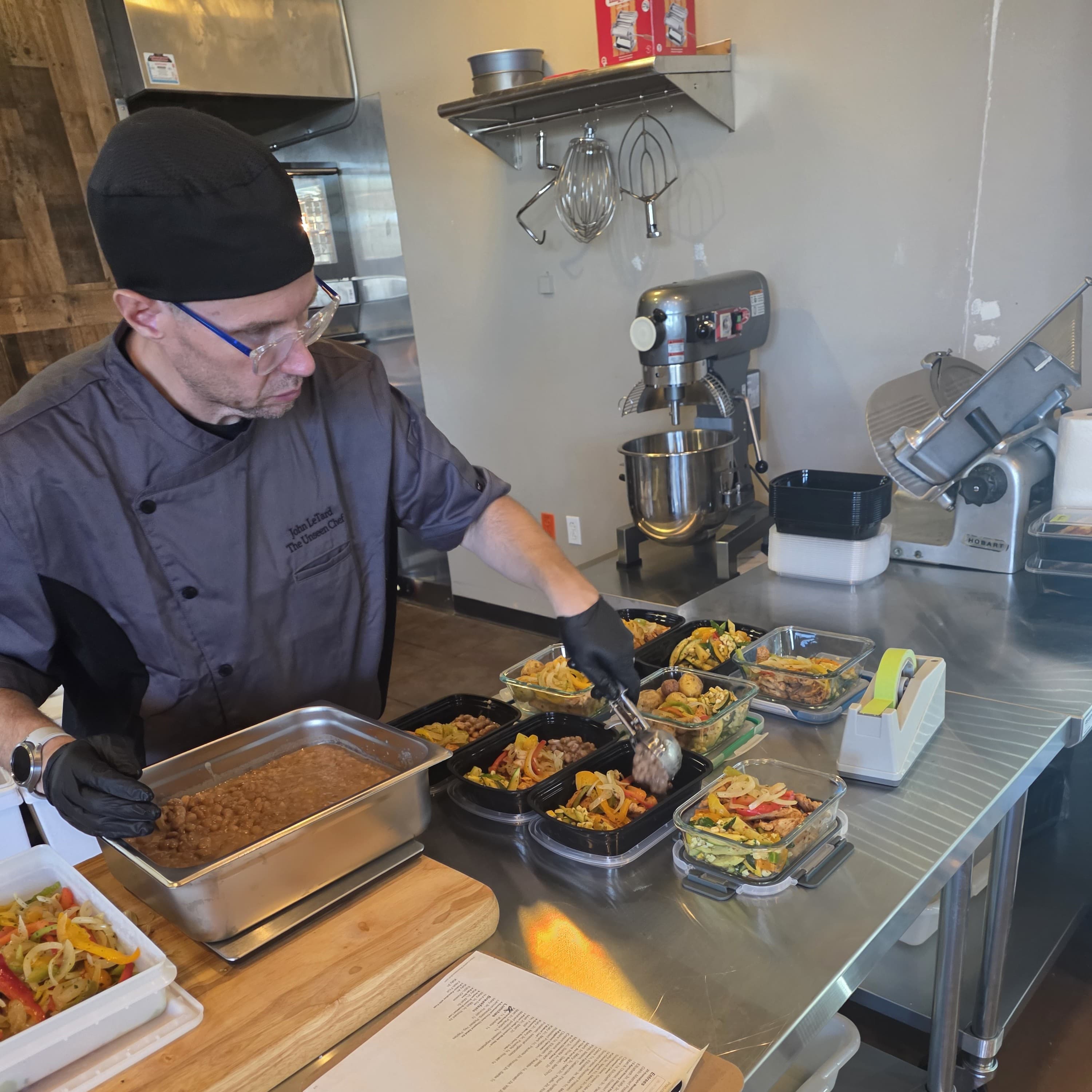 Chef John LeTard preparing weekly meals at The Unseen Chef Studio
