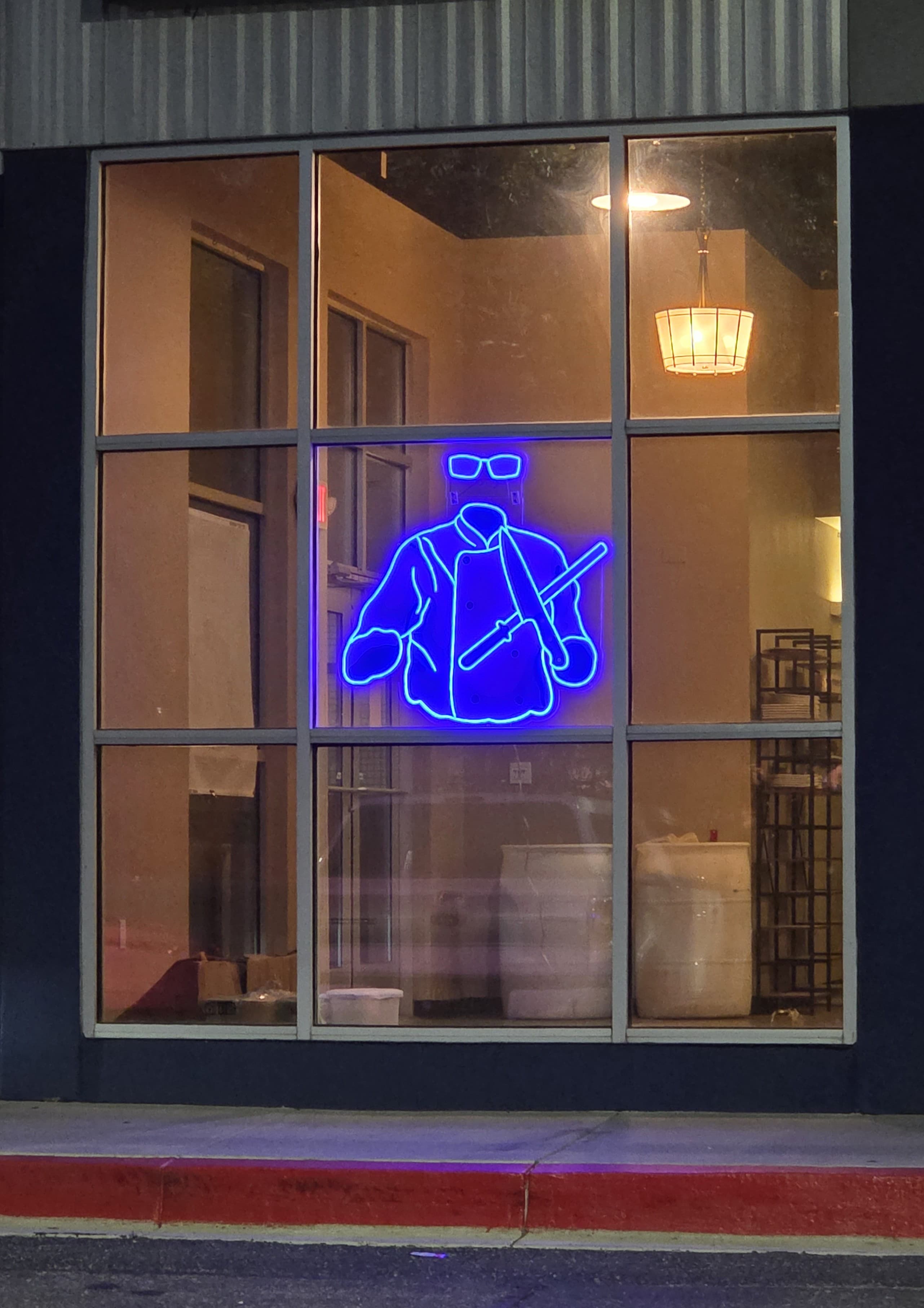 Exterior of The Unseen Chef Studio with illuminated logo