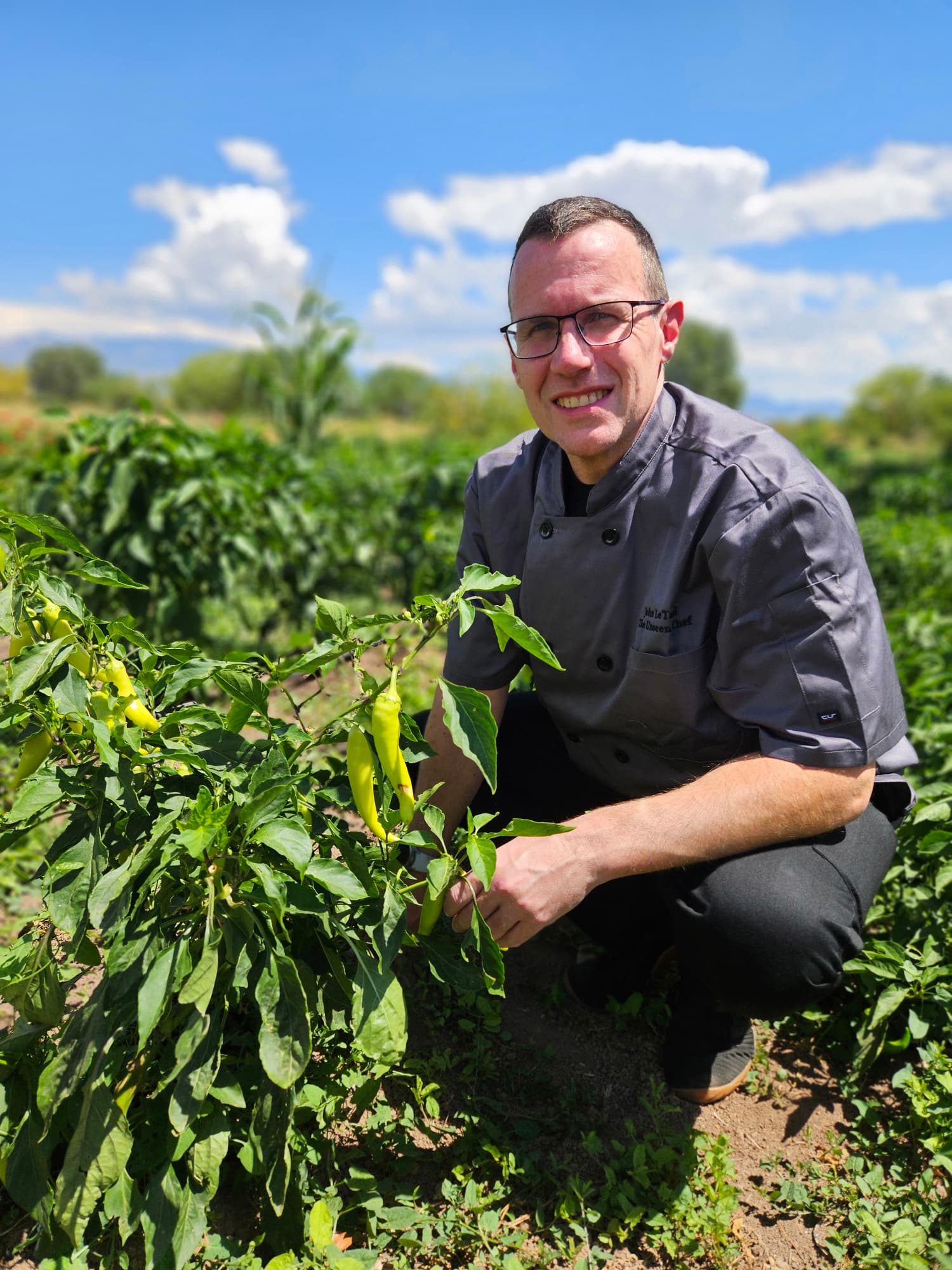 Chef John LeTard standing in a New Mexico chile field