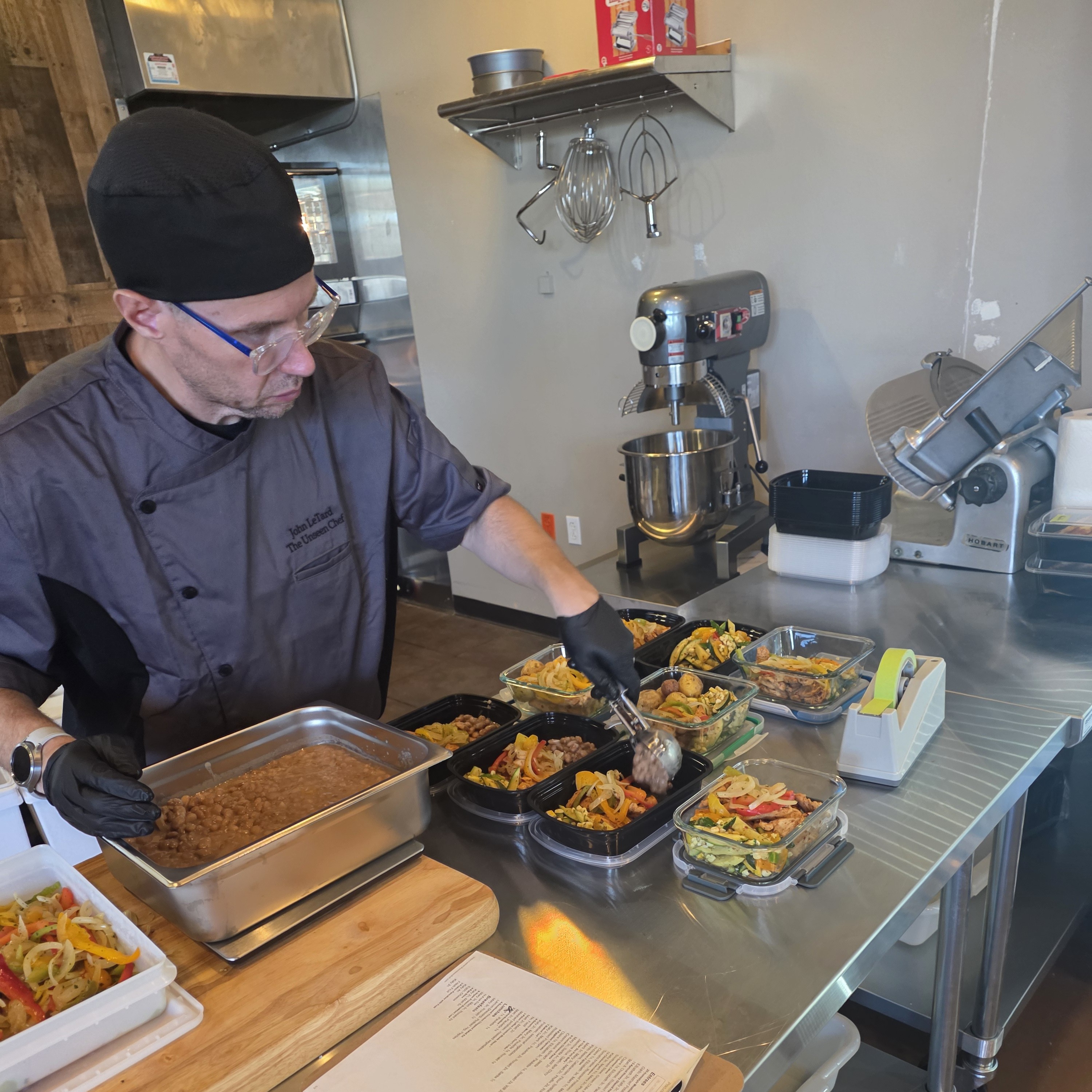 Chef John LeTard preparing weekly meals at The Unseen Chef Studio